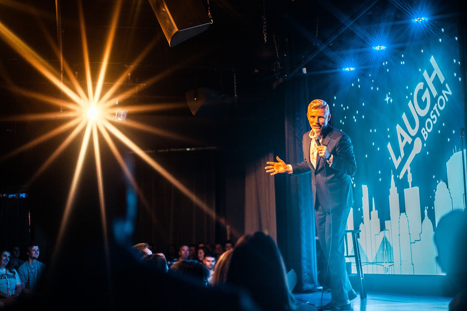 A stand-up comedian performing on the Laugh Boston stage